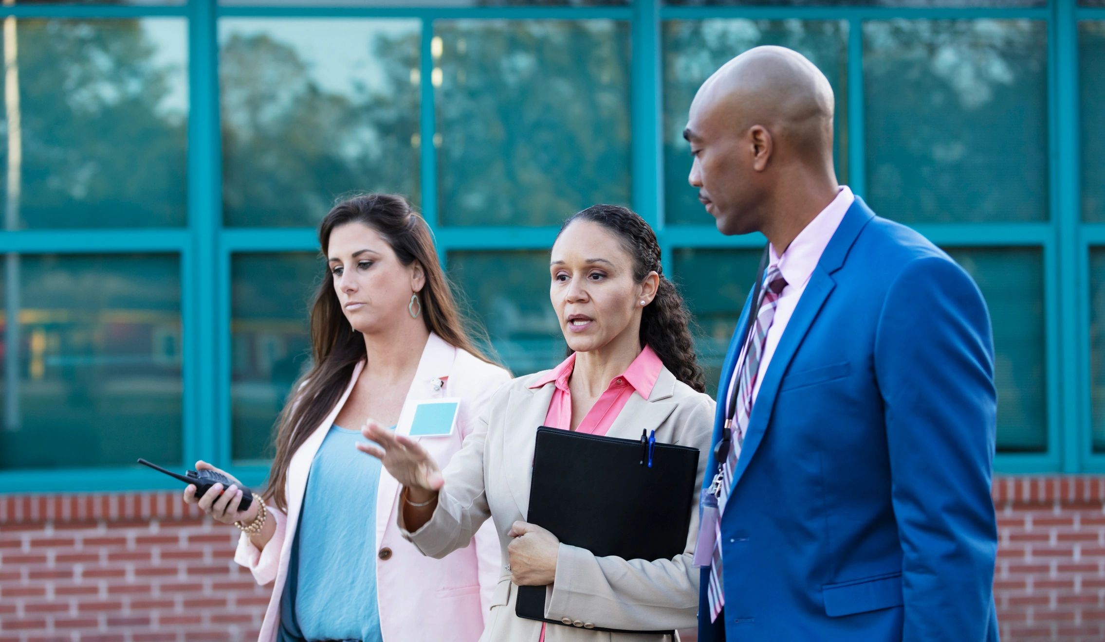 Professionals discussing business matters outside a commercial property
