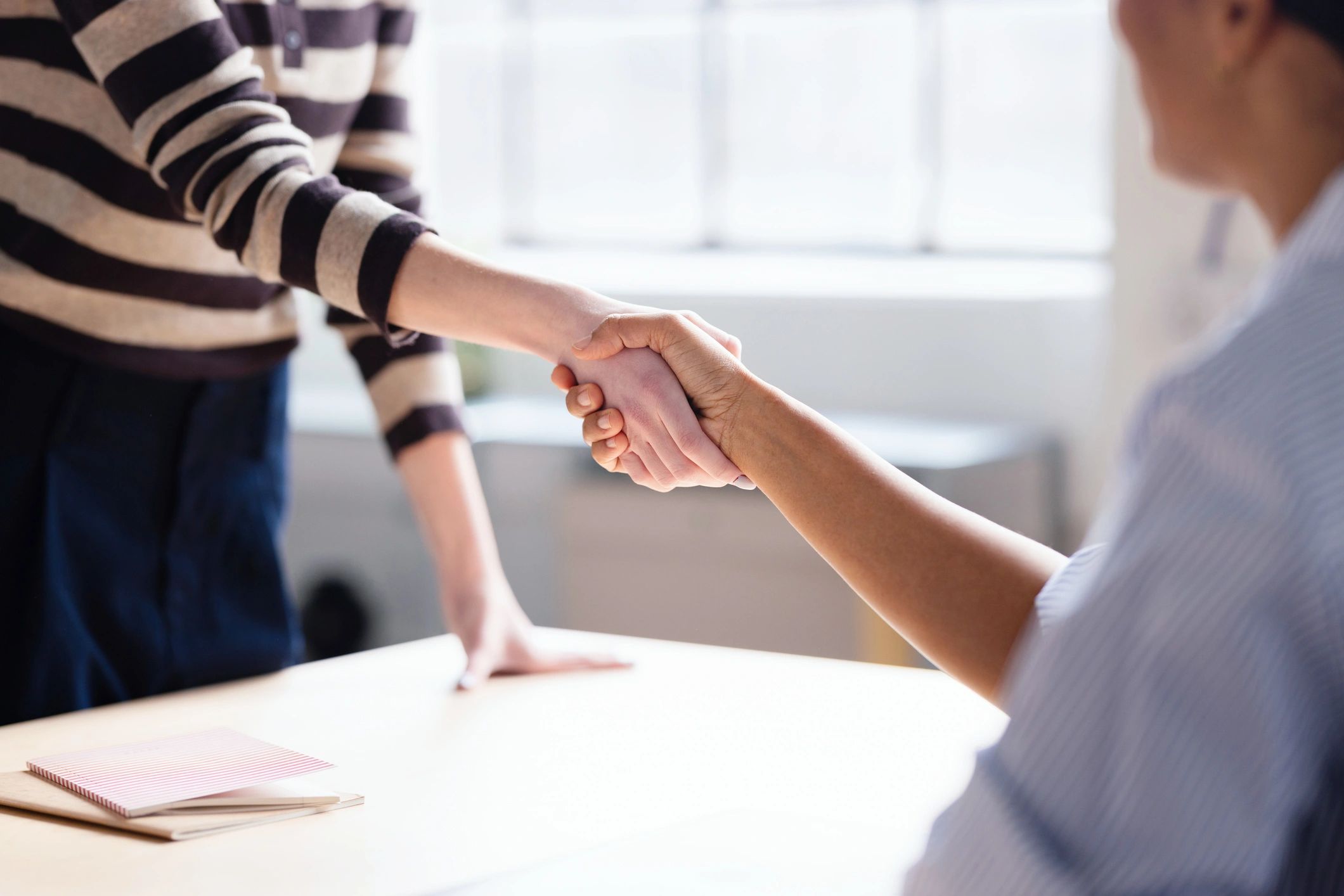 Business handshake representing successful commercial debt recovery